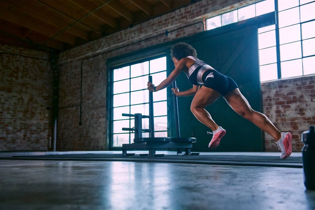 Woman pushing a weight sled
