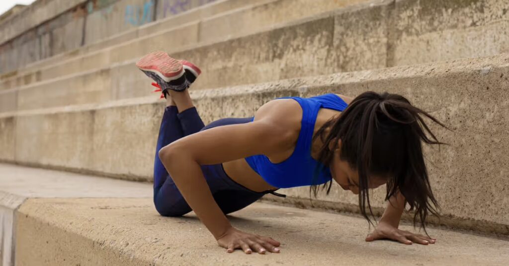 Woman doing push-ups outside