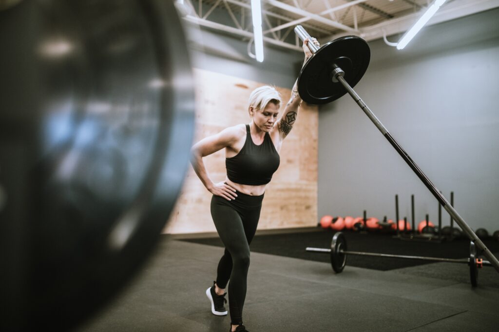 Woman pressing using a landmine exercise attachment